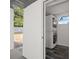 A compact laundry area features stacked washer/dryer with door to outside at 1119 Eau Claire Cir, Tampa, FL 33619