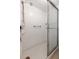 Bright bathroom featuring all-white tile and a glass-enclosed shower at 11485 Oakhurst Rd # 200-101, Largo, FL 33774