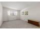 Bright bedroom featuring neutral carpet, paint, and a sunny window with curtains at 11485 Oakhurst Rd # 200-101, Largo, FL 33774
