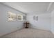 Bright bedroom featuring neutral carpet, paint, and a sunny window with blinds at 11485 Oakhurst Rd # 200-101, Largo, FL 33774