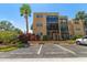Lovely condo exterior featuring reserved parking, mature landscaping, and architectural design elements at 11485 Oakhurst Rd # 200-101, Largo, FL 33774