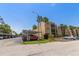 Condo building exterior featuring covered parking, lush landscaping, and a well-maintained facade at 11485 Oakhurst Rd # 200-101, Largo, FL 33774