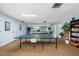 Game room features a ping pong table, pool table, and shelving at 11485 Oakhurst Rd # 200-101, Largo, FL 33774