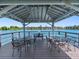Dock gazebo featuring tables, chairs, and beautiful waterfront views at 11485 Oakhurst Rd # 200-101, Largo, FL 33774