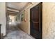 Exterior hallway leading to the front door, textured walls, and natural light at 11485 Oakhurst Rd # 200-101, Largo, FL 33774