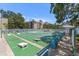 Exterior view of shuffleboard courts with building in the background, benches, and landscaping at 11485 Oakhurst Rd # 200-101, Largo, FL 33774