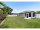 Well-maintained backyard with a large lawn, privacy fence, and screened porch at 11845 Autumn Creek Dr, Riverview, FL 33569