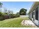 Spacious backyard with lush green grass, privacy fence, and a tiled patio at 11845 Autumn Creek Dr, Riverview, FL 33569