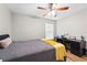 Bedroom boasts wood-look floors, ceiling fan, natural light, and a dark-wood desk at 11845 Autumn Creek Dr, Riverview, FL 33569