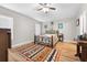 Bright bedroom with decorative rug, wood-look floors, a ceiling fan, and natural light at 11845 Autumn Creek Dr, Riverview, FL 33569