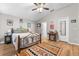 Bright bedroom with decorative rug, wood-look floors, a ceiling fan, and natural light at 11845 Autumn Creek Dr, Riverview, FL 33569