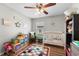 Cozy Bedroom featuring a white crib, colorful rug, and -friendly decor at 11845 Autumn Creek Dr, Riverview, FL 33569
