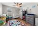 Bright Bedroom featuring wood-look floors, a crib, changing table, and rocking chair at 11845 Autumn Creek Dr, Riverview, FL 33569