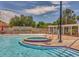 Community pool featuring a bubbling jacuzzi, waterfall feature, and ample seating at 11845 Autumn Creek Dr, Riverview, FL 33569