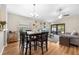 Open-concept dining area with hardwood floors, a ceiling fan, and lots of natural light at 11845 Autumn Creek Dr, Riverview, FL 33569