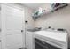 Clean laundry room with modern appliances, shelving and ample storage at 11845 Autumn Creek Dr, Riverview, FL 33569