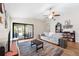 Comfortable living room with a ceiling fan, sliding glass doors to the patio and hardwood floors at 11845 Autumn Creek Dr, Riverview, FL 33569