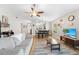 Open concept living room showcases a ceiling fan, wood-look floors, and bright, neutral walls at 11845 Autumn Creek Dr, Riverview, FL 33569