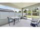 Screened patio with an outdoor dining set and grill, perfect for entertaining at 11845 Autumn Creek Dr, Riverview, FL 33569