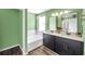 Stylish bathroom with a double vanity, garden tub, and modern gold fixtures at 1204 Rinkfield Pl, Brandon, FL 33511