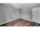 This bedroom features wood floors, neutral paint, and a modern light fixture at 1204 Rinkfield Pl, Brandon, FL 33511