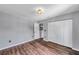 A well lit bedroom has a double closet, wood floors and neutral colored walls at 1204 Rinkfield Pl, Brandon, FL 33511