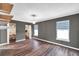 Bedroom with hard surface floors, two windows and two walk-in closets at 1204 Rinkfield Pl, Brandon, FL 33511