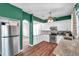 Bright kitchen with stainless steel appliances, granite countertops, and dark wood flooring at 1204 Rinkfield Pl, Brandon, FL 33511