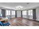 Spacious living room area with an abundance of natural light, wood floors, and modern lighting at 1204 Rinkfield Pl, Brandon, FL 33511