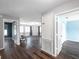 Open-concept living space with wood floors, neutral walls, and a view to the dining area at 1204 Rinkfield Pl, Brandon, FL 33511