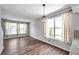 This large living room has wood laminate floors and large windows allowing ample natural light at 1204 Rinkfield Pl, Brandon, FL 33511