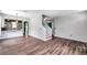This spacious living space featuring wood laminate floors connects the living room and kitchen at 1204 Rinkfield Pl, Brandon, FL 33511