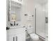 Bathroom with a glass-enclosed shower, marble countertop, and modern fixtures at 121 E Warren Ave # 4, Tampa, FL 33602