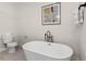 Bathroom featuring white freestanding tub and toilet at 121 E Warren Ave # 4, Tampa, FL 33602