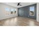 Bright bedroom with hardwood flooring, a decorative wall, and three large windows at 121 E Warren Ave # 4, Tampa, FL 33602