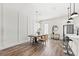 Elegant dining area with stylish chandelier, modern decor, hardwood floors and view of the kitchen at 121 E Warren Ave # 4, Tampa, FL 33602