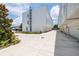 Wide driveway leading to modern townhomes with well-maintained landscaping and a clear sky at 121 E Warren Ave # 4, Tampa, FL 33602