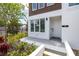Inviting home exterior with a white door, large window, and fresh landscaping at 121 E Warren Ave # 4, Tampa, FL 33602