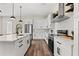 Bright open kitchen with white cabinets, stainless steel appliances, an island and modern finishes at 121 E Warren Ave # 4, Tampa, FL 33602