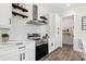 Close-up of the kitchen with stainless steel stove, white countertop, white tiled backsplash and pantry at 121 E Warren Ave # 4, Tampa, FL 33602