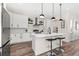 Bright kitchen with white cabinets, stainless steel appliances, and a marble-topped island at 121 E Warren Ave # 4, Tampa, FL 33602