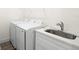 Well-lit laundry area with washer, dryer, stainless sink, and ample countertop space at 121 E Warren Ave # 4, Tampa, FL 33602