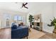 Bright living room featuring a blue sofa, wood floors, natural light, a ceiling fan and stylish decor at 121 E Warren Ave # 4, Tampa, FL 33602