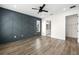 The main bedroom includes decorative wall, hardwood flooring, and a view to the main bathroom at 121 E Warren Ave # 4, Tampa, FL 33602