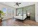 Stylish bedroom features an accent wall and a sleek canopy bed framed by natural light at 121 E Warren Ave # 4, Tampa, FL 33602
