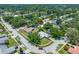 Aerial view of a home with an in-ground pool, mature trees and lush landscaping at 1211 Stony Brook Ln, Dunedin, FL 34698