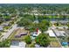 Aerial view of a home with an in-ground pool, mature trees and lush landscaping at 1211 Stony Brook Ln, Dunedin, FL 34698