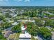 Aerial view of a home with an in-ground pool, mature trees and lush landscaping at 1211 Stony Brook Ln, Dunedin, FL 34698