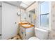 This bathroom features a vanity, toilet, patterned wallpaper, and a mirror at 1211 Stony Brook Ln, Dunedin, FL 34698