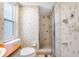 The bathroom includes a shower stall, floral wallpaper, and a toilet at 1211 Stony Brook Ln, Dunedin, FL 34698